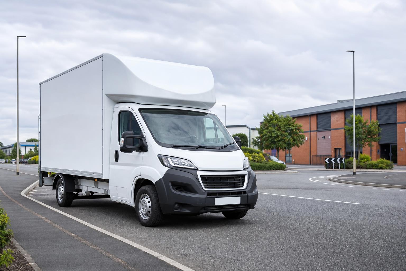Clean white Luton hire van parked near a light industrial estate in Castleford